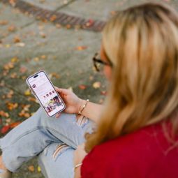 Person looking at uofscstudents instagram profile on their mobile phone