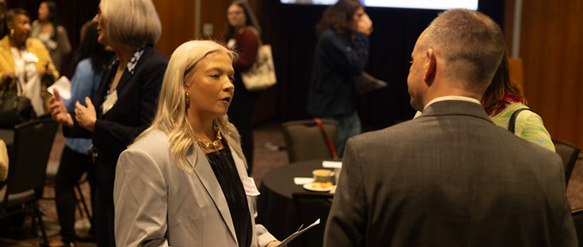 Kaitlyn Byrne, Class of 2025, speaks with an attendee during McCausland Mentoring Night at the University of South Carolina.