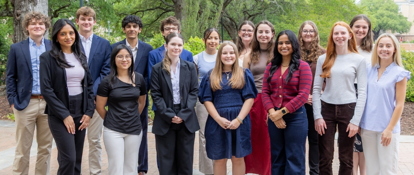 A group of students pose on campus