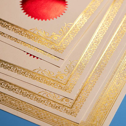 stack of awards certificates edged in gold leaf and stamped with garnet seals