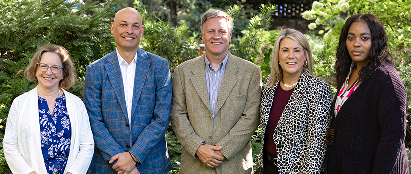HRSM employees Tammy Macek, Michael Sagas, Collin Crick, Tina Weeks Weaver and Jasmyn Herman pose in a garden.