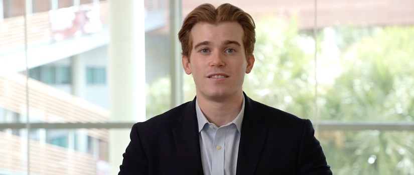 male student talking to someone off camera