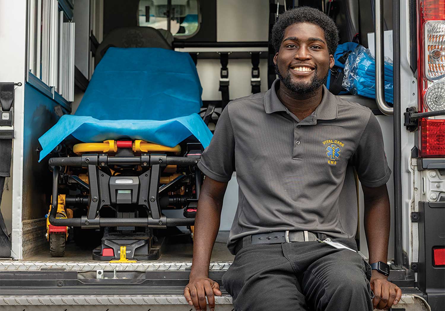 Tremayne Ansani sits in the tailgate of an ambulance.