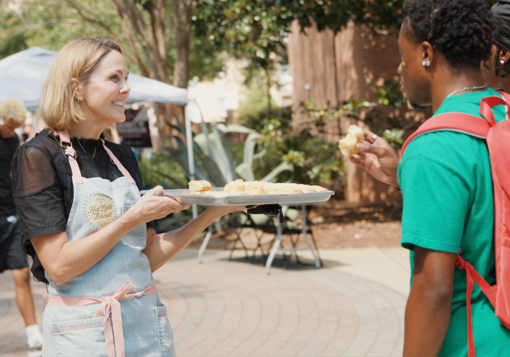 Carrie Morey serves biscuits to a student outside USC's Russell House. 