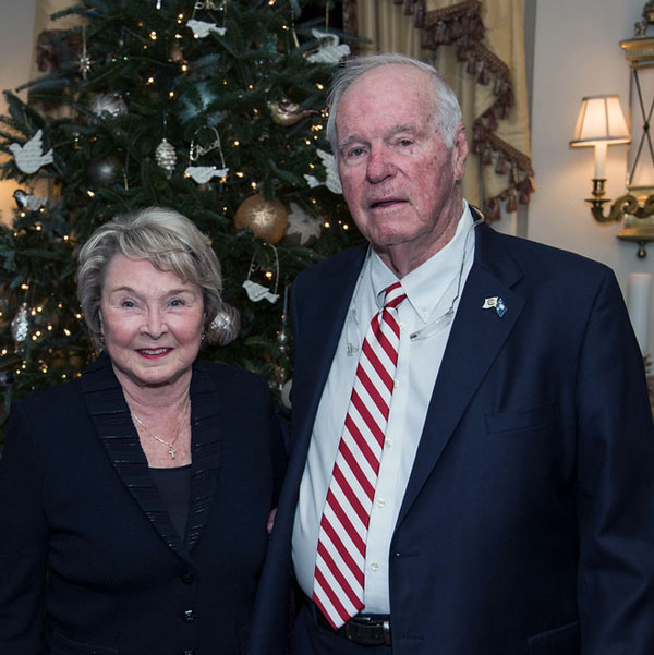 Eddie Floyd, right, and his late wife, Kay, stand in front of a Christmas tree