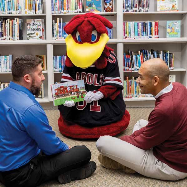 Cocky reads with (left) Jamie Ballentine and Tommy Preston