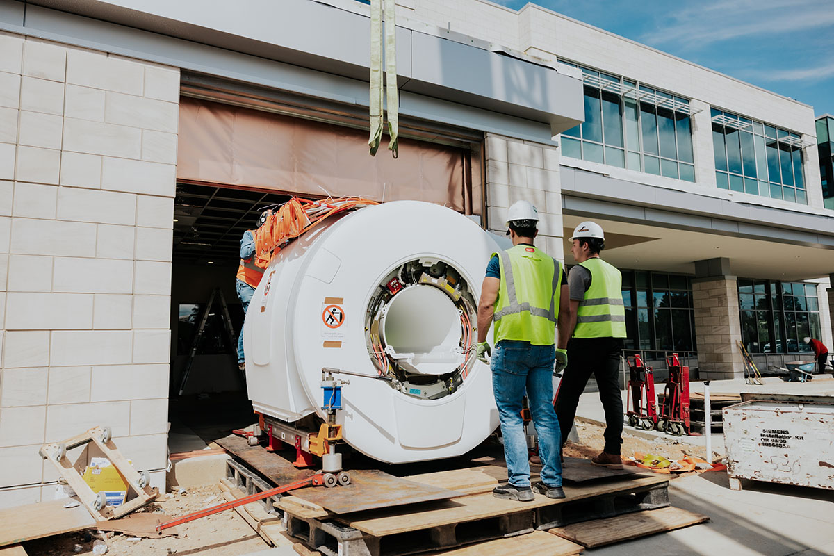 Workers install a 3-Tesla MRI scanner at USC's Brain Health Center on March 9.